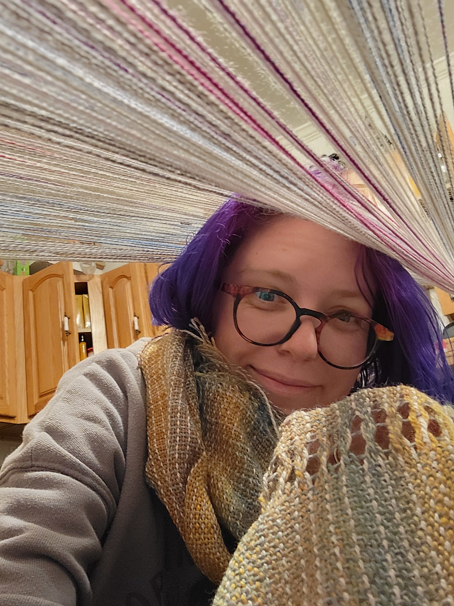 Tying on the new warp while wearing the first shawl